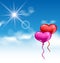 Two glossy hearts balloons for Valentine Day flying in the blue