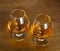 Two goblets of brandy on wooden counter top