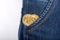 Two gold bitcoin in man pocket jeans.