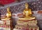 Two Gold-colored Buddha statue in Buddhist temple