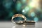 Two gold wedding rings are in front of a bokeh background, in the style of digitally enhanced, light green