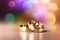 Two gold wedding rings are in front of a pastel bokeh background, in the style of digitally enhanced,