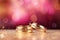 Two gold wedding rings are in front of a pink bokeh background, in the style of digitally enhanced,