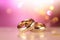 Two gold wedding rings are in front of a pink bokeh background, in the style of digitally enhanced,