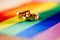 Two gold wedding rings on rainbow lgbt flag. Homosexual marriage