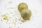 Two golden christmas balls baubles on a white background with blurry golden stars