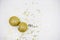 Two golden christmas balls baubles on a white background with blurry golden stars