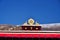 Two golden deer flanking a Dharma wheel on Drepung Monastery