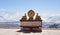 Two golden deer flanking a Dharma wheel on Drepung Monastery