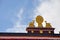 Two golden deer flanking a Dharma wheel on Ramoche Temple