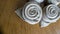 two golden napkin origami roses over wooden background ready for event parties celebration and holidays in right corner
