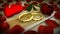 Two golden wedding rings and red rose with petals