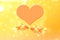Two goldfish in love and heart symbol on a yellow background