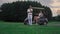 Two golfers rest outdoors on golf course. Married couple relax in golf cart.