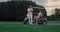 Two golfers rest outdoors on golf course. Married couple relax in golf cart.