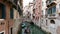 Two gondolas navigating narrow canals in Venice, Italy 4k