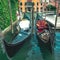 Two gondolas parked on a canal in venice