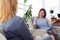 Two good-looking females chatting while drinking coffee in living room