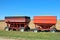 Two grain wagons filled with golden colored corn.