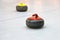 Two granite stones for curling game on the ice