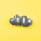 Two gray hearts on a bright yellow background