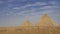 Two great pyramids of Cheops and Chephren on a background of blue sky and clouds.