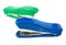 Two green and blue staplers on a white background