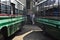 Two green buses on the bus station