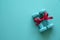 Two green dumbbell with red gift bow on a green table background