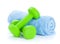 Two green dumbells and towel