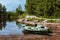 Two green empty fishing boats on a shore of a lake