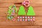 Two green felt Christmas trees, pink and blue balls set, scissors, felt scraps on a wooden table