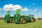 Two green John Deere tractors pulling bunning muck spreaders