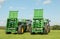 Two green John Deere tractors pulling bunning muck spreaders