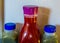 Two green and one red fruit juice in plastic bottles, healthy smoothies in the refrigerator, popular and healthy products
