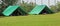 Two green tents mounted in a meadow by the scouts