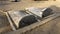 Two grey colored stone graves with tombstones at Bena a traditional village of the Ngada people in Flores.