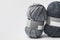 Two grey yarn balls with blank tag