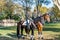 Two guards riding horses and wearing green uniform in the park Topkapi Palace in autumn, Istanbul, Turkey