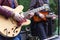 Two guitarists playing outside during the day