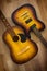 Two guitars acoustic and electric on wooden background