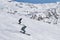 Two guys on alpine skiing descends the snowy slope of Cheget mountain