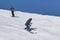 Two guys on alpine skiing descends the snowy slope of Cheget mountain
