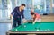 Two guys in pool billiard club playing pool billiard