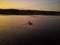 Two guys rolling around on a boat on the river. The view from the top. Photo from quadrocopter. Two guys sitting in a boat.