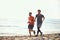 Two guys running along the beach coast