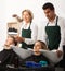 Two hairstylists working with hair of clients in washing tray