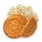 Two and half crunchy oat and wholemeal biscuits on a heap of oats isolated on white. Top view