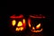 Two Halloween glowing pumpkins isolated dark background