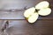 Two halves apple , pieces of a red apple on the table, red apples on a brown background.